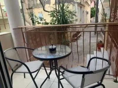 a small table and two chairs on a balcony at Modern & Lovely Apartment Downtown Near Acropolis in Athens