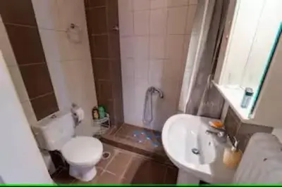a small bathroom with a toilet and a sink at Modern & Lovely Apartment Downtown Near Acropolis in Athens