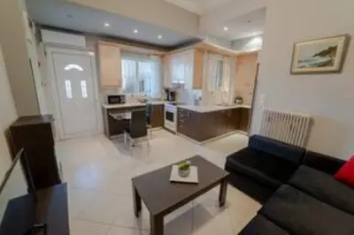 a large living room with a couch and a table at Modern & Lovely Apartment Downtown Near Acropolis in Athens