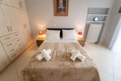 a bedroom with a bed with two crosses on it at Modern & Lovely Apartment Downtown Near Acropolis in Athens