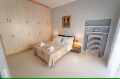 a bedroom with a large bed in a room at Modern & Lovely Apartment Downtown Near Acropolis in Athens