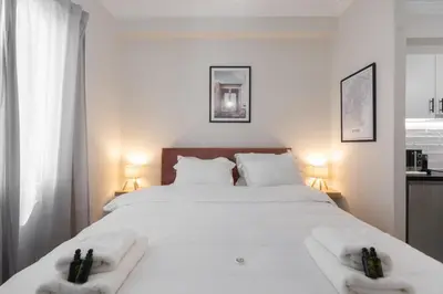 a bedroom with a large white bed with towels on it at Cozy Studio in Plaka 10 Minutes From Acropolis in Athens