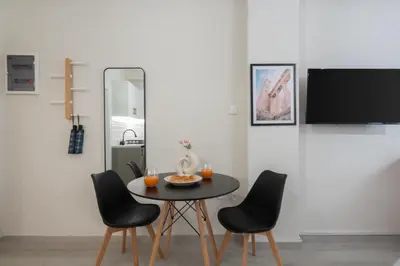 a dining room with a table and four chairs at Cozy Studio in Plaka 10 Minutes From Acropolis in Athens