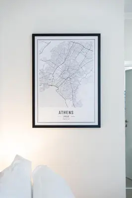 a framed map of athens on a wall above a couch at Cozy Studio in Plaka 10 Minutes From Acropolis in Athens