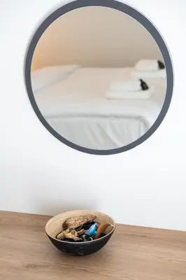 a bowl of rocks on a table in front of a mirror at 1BR Apt with Backyard in Plaka 10 From Acropolis in Athens