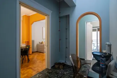 a hallway with a mirror and a dining room at Pangrati Subtle Deluxe Minimalism in Athens
