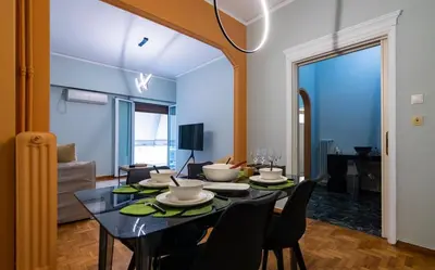 a dining room with a table and chairs at Pangrati Subtle Deluxe Minimalism in Athens