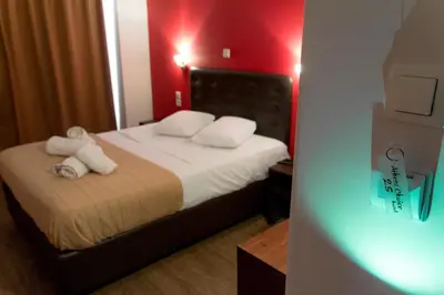 a bedroom with a bed with white towels on it at Athens Choice Hotel in Athens