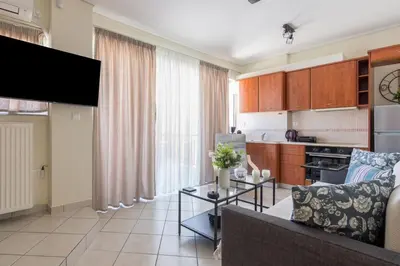 a living room with a couch and a table at Apartment with a private rooftop in Piraeus