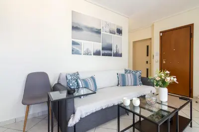 a living room with a couch and a table at Apartment with a private rooftop in Piraeus