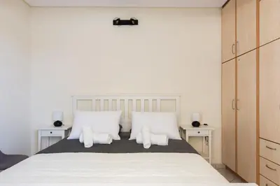 a bedroom with a large bed with white pillows at Apartment with a private rooftop in Piraeus