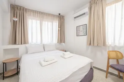 a bedroom with a white bed with two towels on it at Centric Romantic Studio Zen Clio, Tessera Urban Apartments in Athens