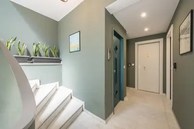 a hallway with stairs and a door with plants at Centric Romantic Studio Zen Clio, Tessera Urban Apartments in Athens