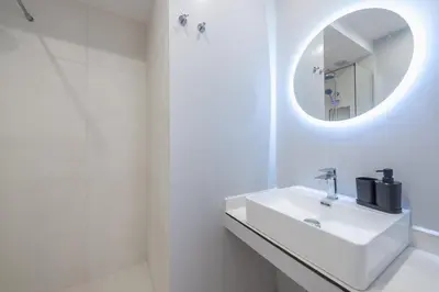 a white bathroom with a sink and a mirror at Centric Romantic Studio Zen Clio, Tessera Urban Apartments in Athens