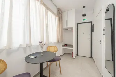 a room with a table and two chairs and a window at Centric Romantic Studio Zen Clio, Tessera Urban Apartments in Athens