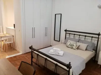 a bedroom with a bed with two towels on it at Modern Studio for 2 persons in the Heart of Athens in Athens