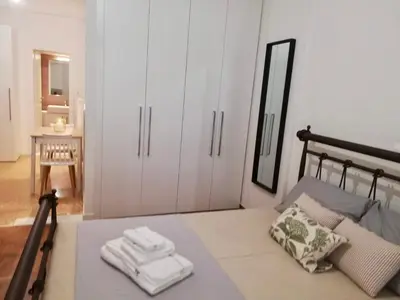 a bedroom with a bed with two towels on it at Modern Studio for 2 persons in the Heart of Athens in Athens