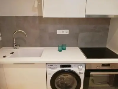 a kitchen with a sink and a washing machine at Modern Studio for 2 persons in the Heart of Athens in Athens