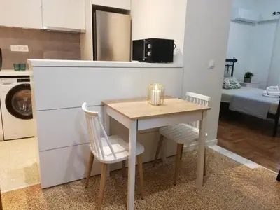 a small table and chairs in a kitchen with a room at Modern Studio for 2 persons in the Heart of Athens in Athens