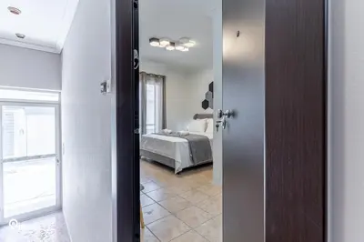 a door to a bedroom with a bed in a room at Simple and Comfy - Modern Urban Escape in Egaleo-Athens in Athens