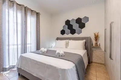 a bedroom with a bed with two towels on it at Simple and Comfy - Modern Urban Escape in Egaleo-Athens in Athens