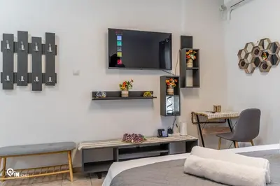 a room with a bed and a tv on the wall at Simple and Comfy - Modern Urban Escape in Egaleo-Athens in Athens