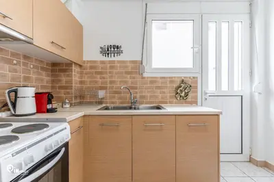 a kitchen with a sink and a stove at Simple and Comfy - Modern Urban Escape in Egaleo-Athens in Athens