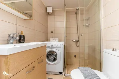 a bathroom with a washing machine and a shower at Simple and Comfy - Modern Urban Escape in Egaleo-Athens in Athens