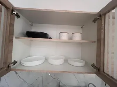 three white bowls sitting on shelves in a room at Olvia 10 in Athens