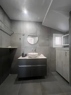a bathroom with a sink and a mirror at Olvia 10 in Athens