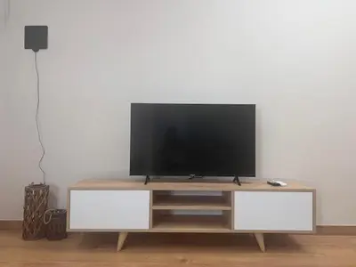 a flat screen tv sitting on top of a entertainment center at Olvia 10 in Athens
