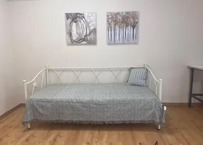 a bed in a room with two pictures on the wall at Olvia 10 in Athens
