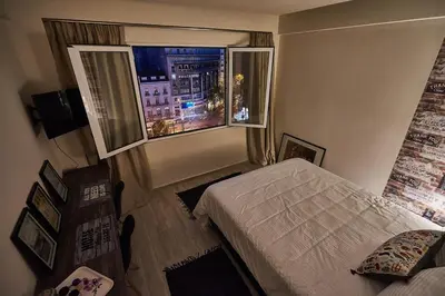 a small bedroom with a bed and a window at Lycabettus View 2, brand-new, central, cozy studio in Athens
