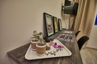 a table with a plate with two bottles on it at Lycabettus View 2, brand-new, central, cozy studio in Athens
