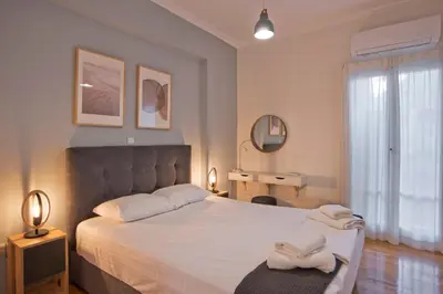 a bedroom with a bed with two towels on it at Charming Kallithea Apt, fully Reno, Fully Equipped in Athens