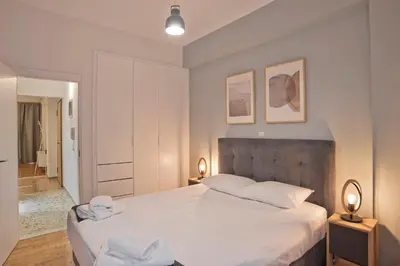 a bedroom with a large bed with two towels on it at Charming Kallithea Apt, fully Reno, Fully Equipped in Athens