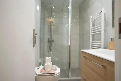 a bathroom with a shower and a toilet and a sink at Charming Kallithea Apt, fully Reno, Fully Equipped in Athens