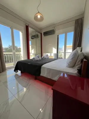 a bedroom with a large bed with a large window at Sea La Vie, Glyfada in Athens