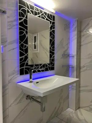 a bathroom with a white sink and a mirror at Sea La Vie, Glyfada in Athens