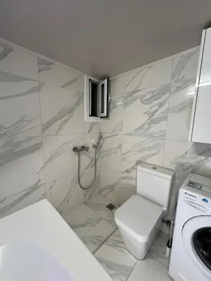 a white bathroom with a toilet and a sink at Sea La Vie, Glyfada in Athens
