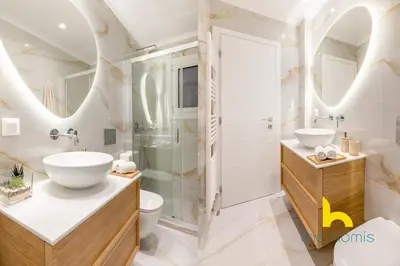 a bathroom with two sinks and a shower at Radiant 3BR in Pireas Near Marina Zeas and Metro in Piraeus