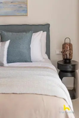 a bedroom with a bed and a lamp on a night stand at Radiant 3BR in Pireas Near Marina Zeas and Metro in Piraeus