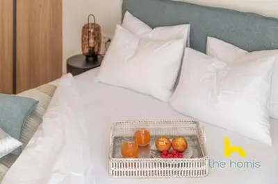 a tray of fruits and oranges on a bed at Radiant 3BR in Pireas Near Marina Zeas and Metro in Piraeus