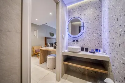 a bathroom with a sink and a mirror at Acropolis Museum Studios in Athens