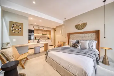 a bedroom with a large bed and a kitchen at Acropolis Museum Studios in Athens