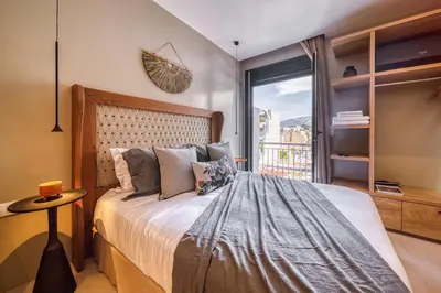 a bedroom with a large bed and a window at Acropolis Museum Studios in Athens