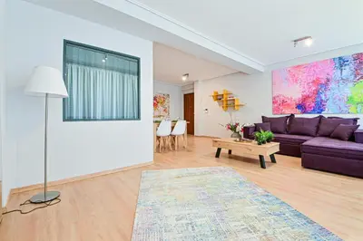 a living room with a purple couch and a table at 2 Bedroom Apartment near Piraeus Port B1 in Piraeus