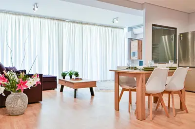 a kitchen and living room with a table and chairs at 2 Bedroom Apartment near Piraeus Port B1 in Piraeus