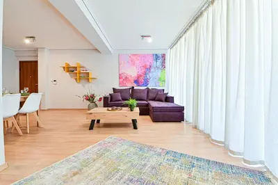 a living room with a purple couch and a table at 2 Bedroom Apartment near Piraeus Port B1 in Piraeus