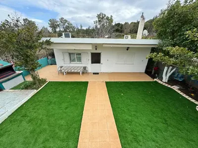 a house with a green lawn in front of it at DianaHub in Artemida